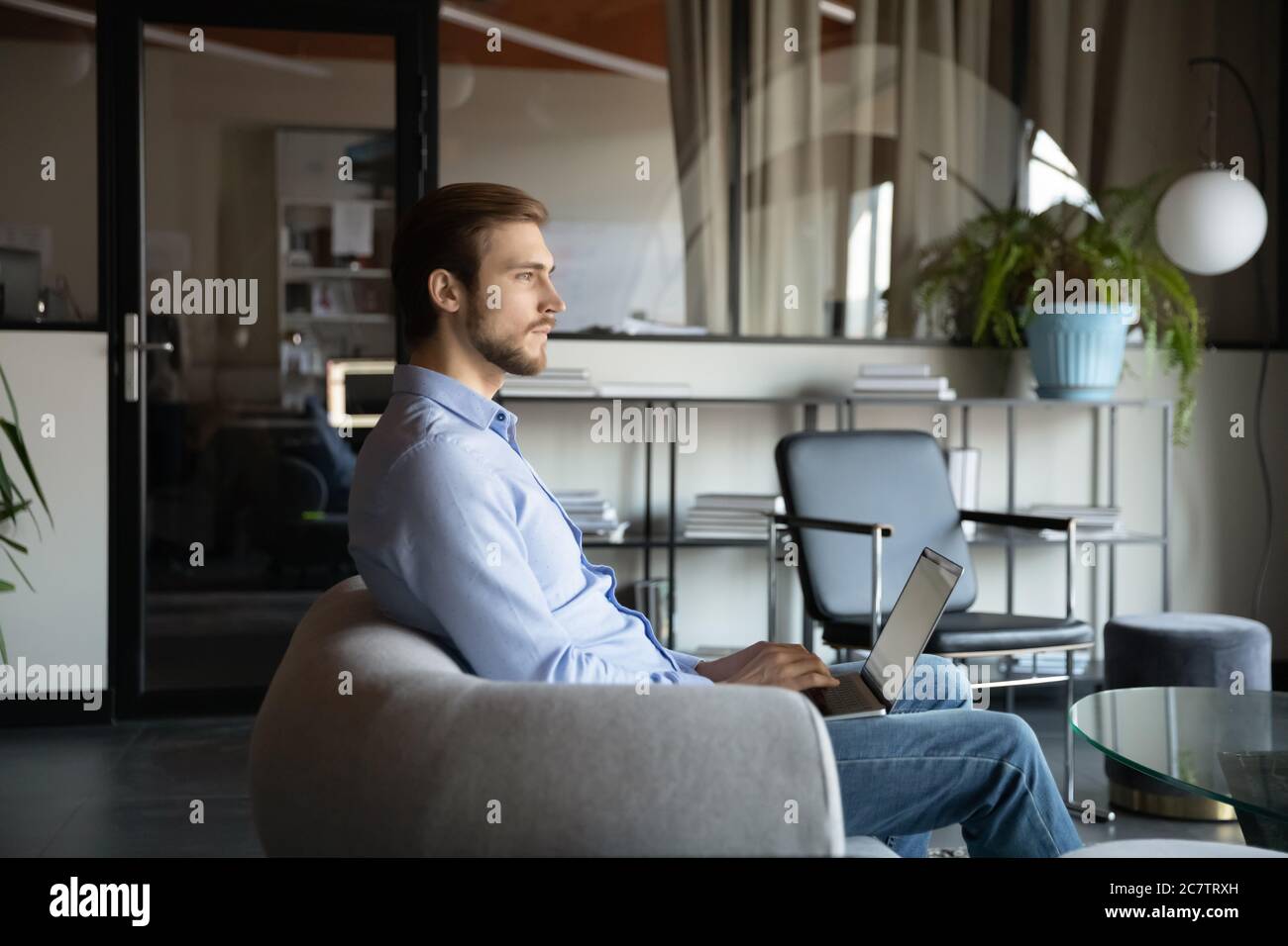 Caucasian businessman distracted from office computer work thinking Stock Photo