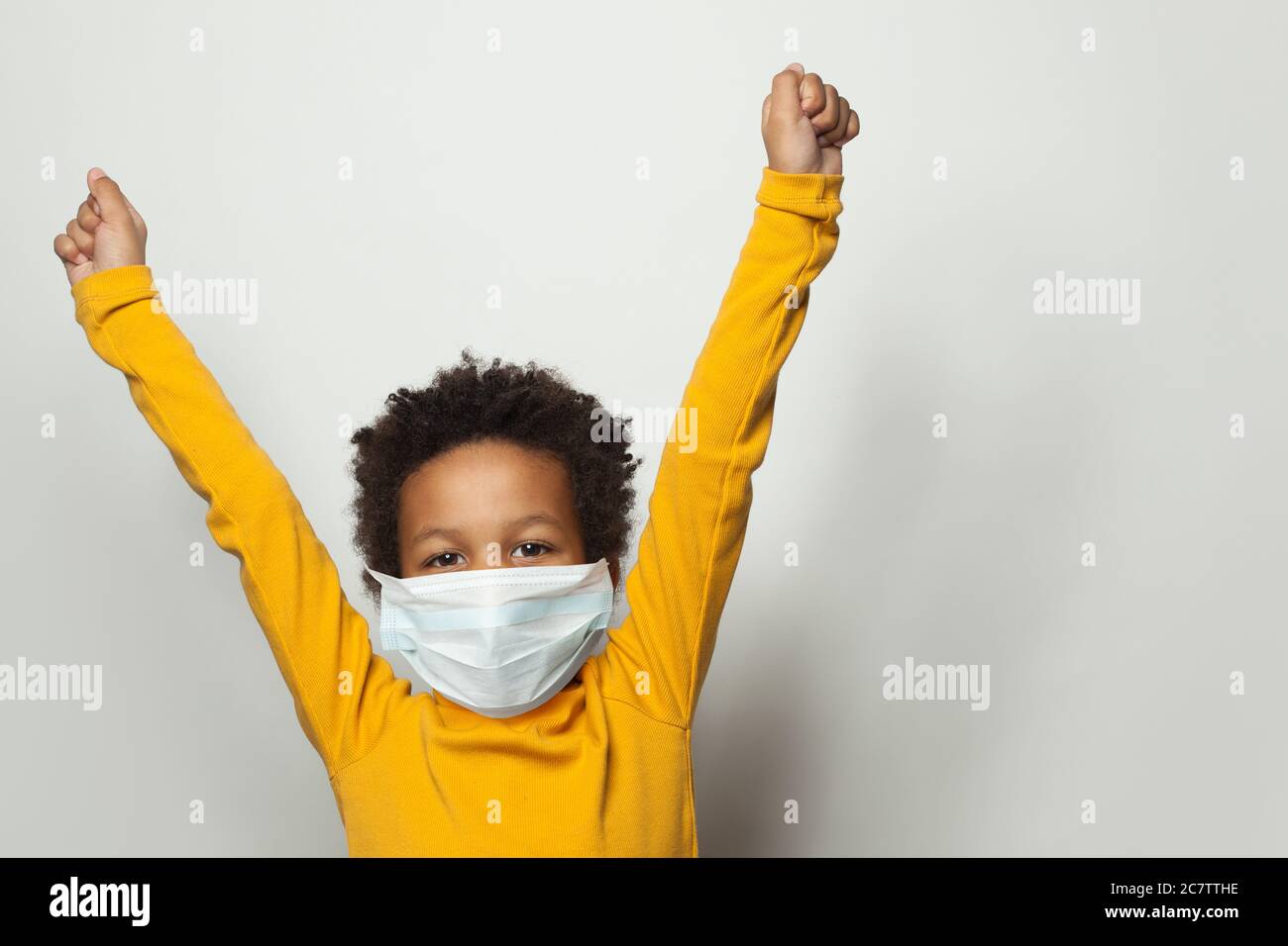 Portrait of happy black child boy in medical protective face mask ...