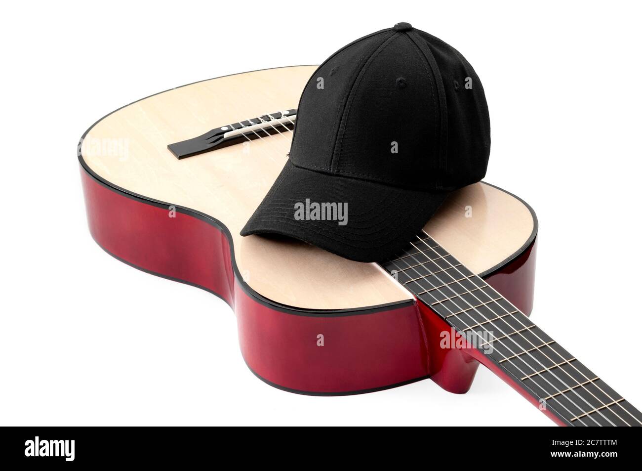 American culture, folk song and country music concept theme with a black baseball cap and an acoustic guitar isolated on white background with clippin Stock Photo