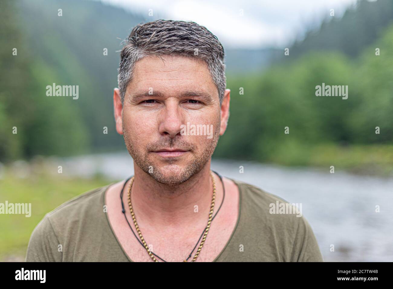 Portrait of an attractive young man against a background of nature. Stock Photo