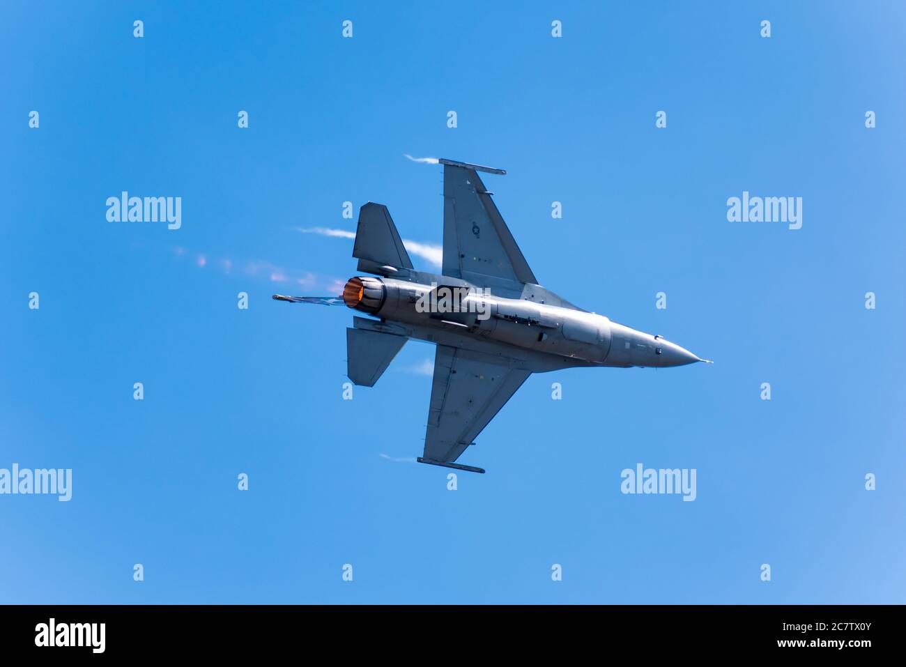 F16 Viper Demo Team flying, water vapor streaming off the wings, at the Rhode Island National Guard Airshow/ Stock Photo