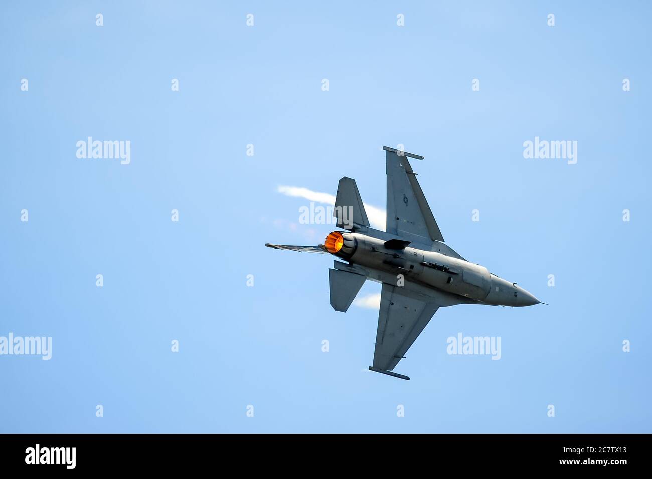 F-16 fighter jet with the Viper Demo Team ascending up into the sky. Stock Photo