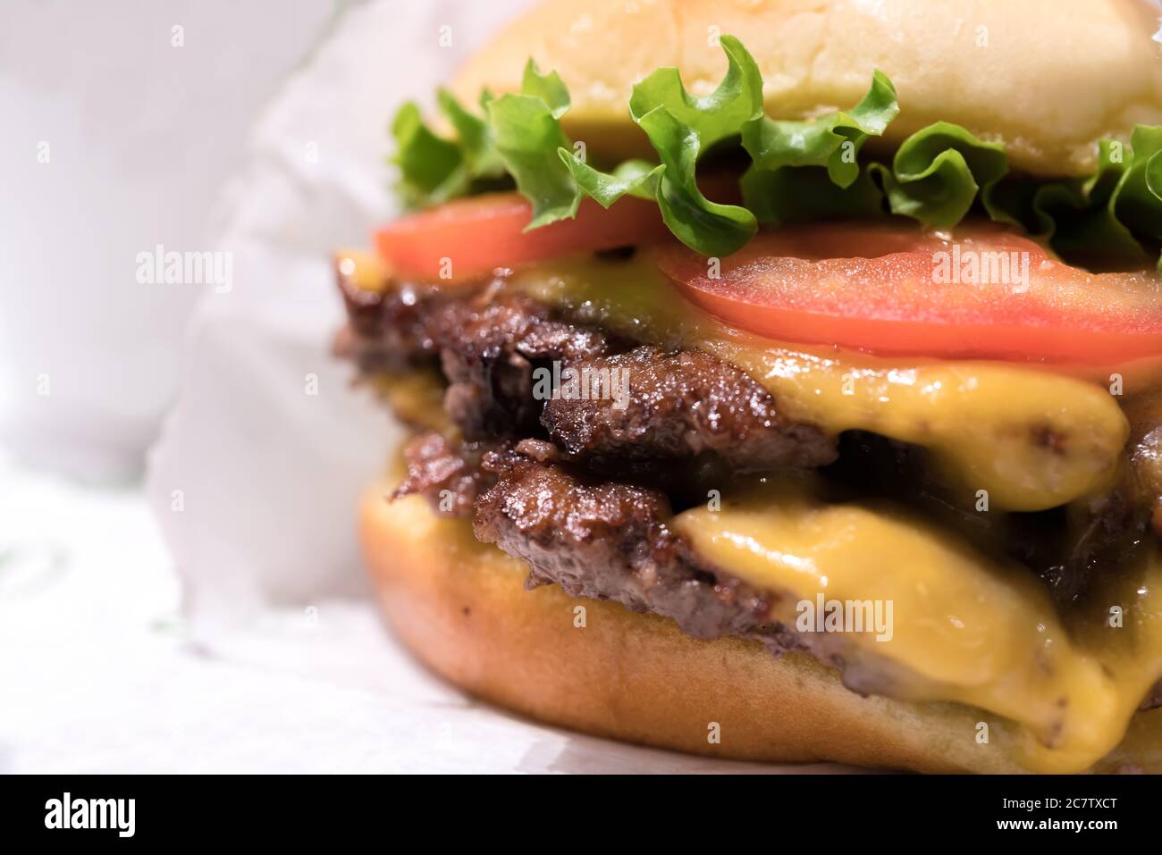 Double cheeseburger with tomato lettuce and onion, Cheese Fries and Milkshake. Stock Photo