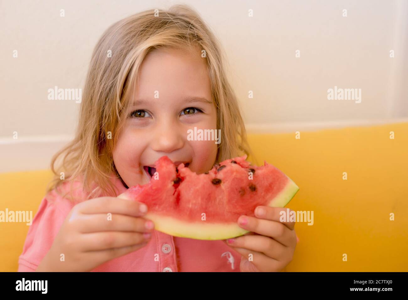 Caucasian girl happily eating a watermelon Stock Photo
