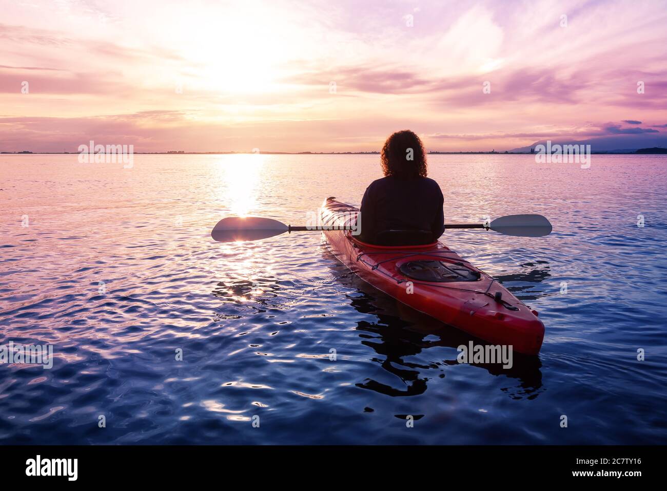 Sea Kayaking in calm waters during a colorful and vibrant sunset Stock ...