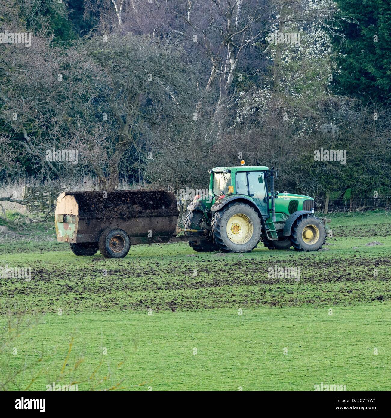 Tractor drawn mechanical manure spreader hires stock photography and