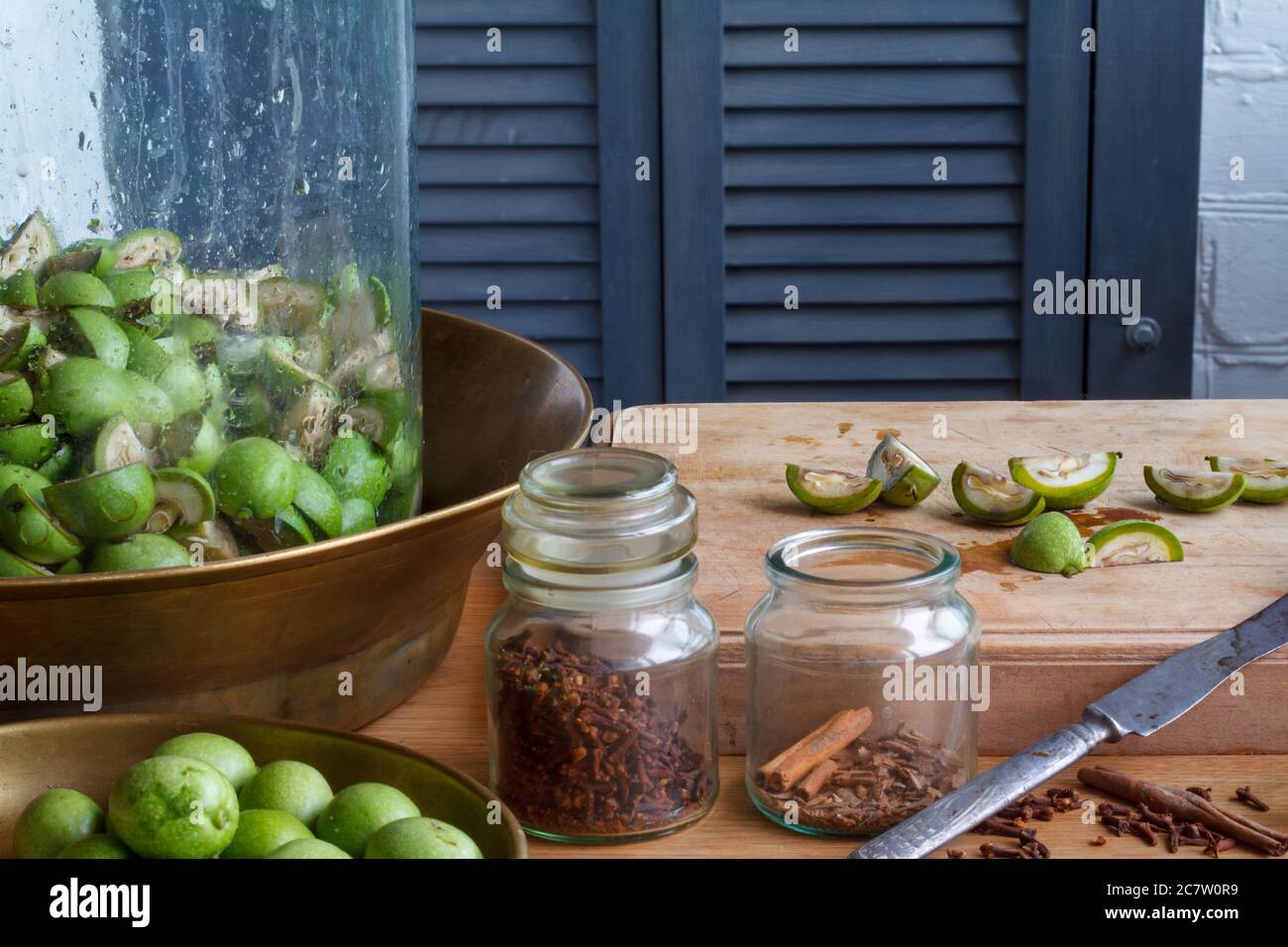 Step-by-step recipe for preparing Italian liquor nocino from green walnuts at home, real home kitchen and cooking, selective focus Stock Photo