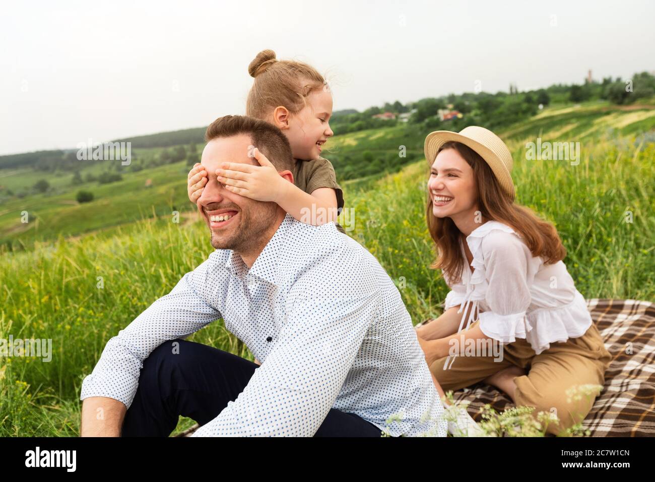 Happy young family playing together on a picnic Stock Photo
