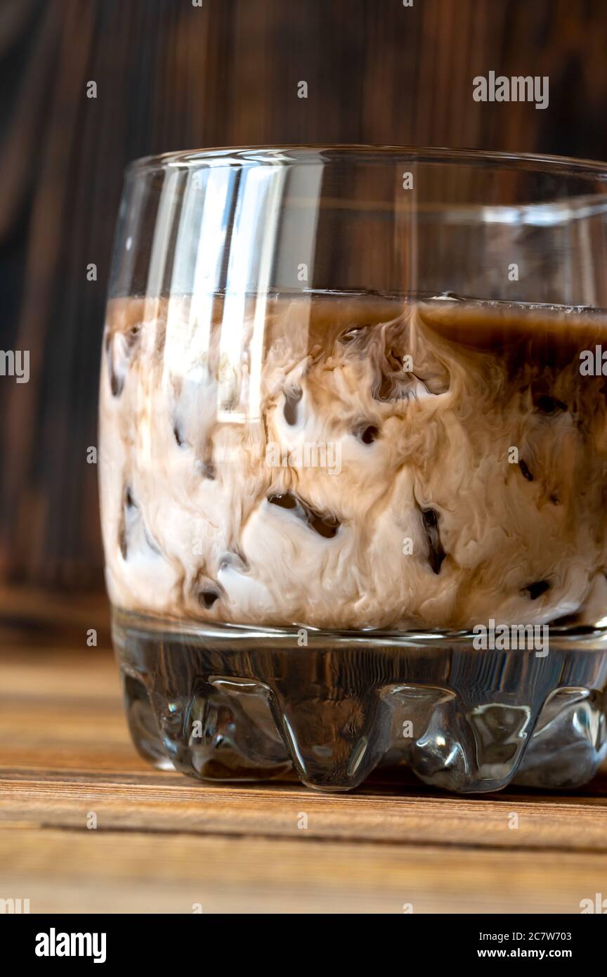 Glass of White Russian cocktail. Combining vodka, coffee liqueur and