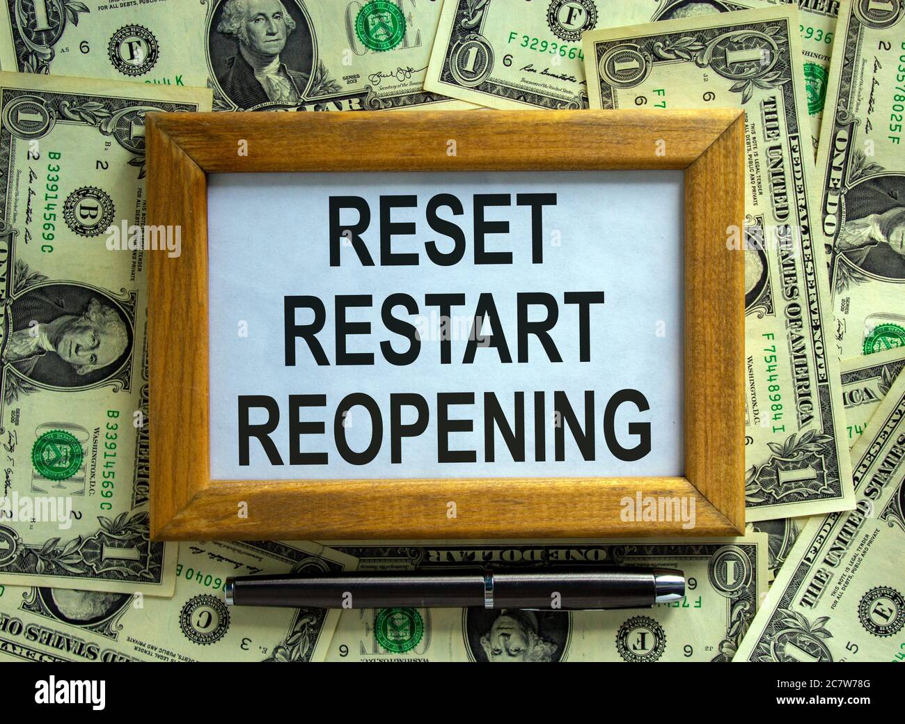 Wooden picture frame with inscription 'reset restart reopening' on