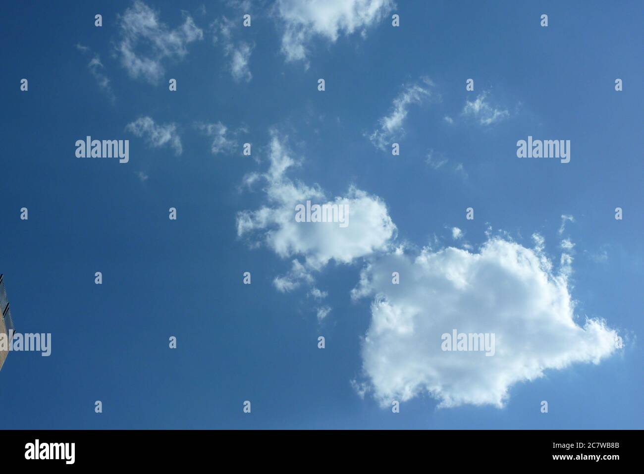 Low angle shot of a blue sky with few clouds Stock Photo - Alamy
