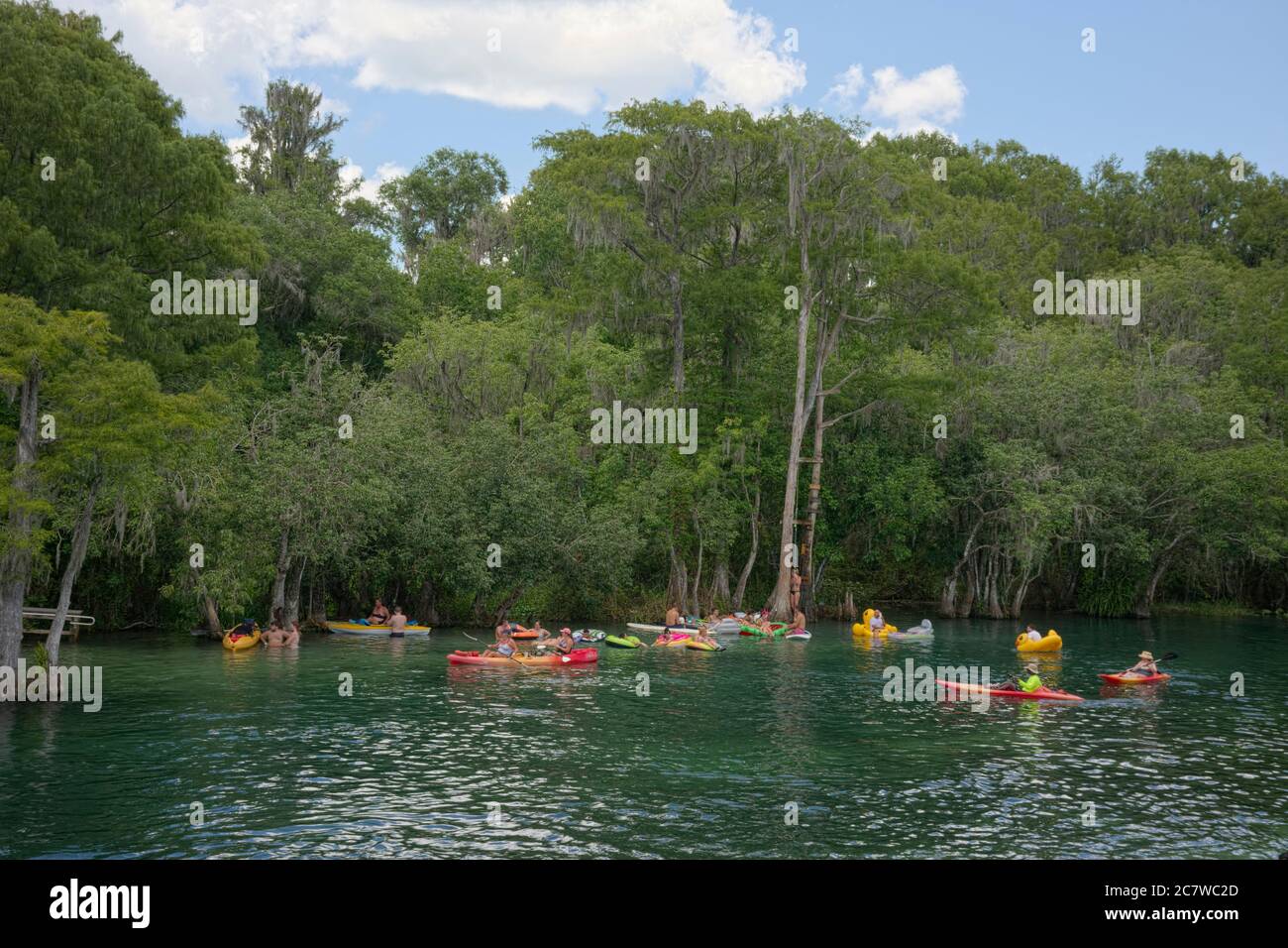 People enjoying the clear spring fed Rainbow River water in Dunnellon, Florida. A popular vacation spot for tourists and locals. Marion County Florida Stock Photo