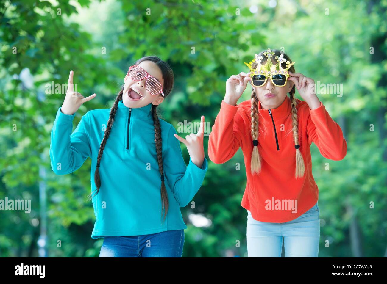 All the fun of primary school prom. Cool look of prom girls. Happy children wear fancy glasses. Fashion accessories. Prom party. Beauty pageants. Big boss. Summer vacation. Relax its going to be easy. Stock Photo