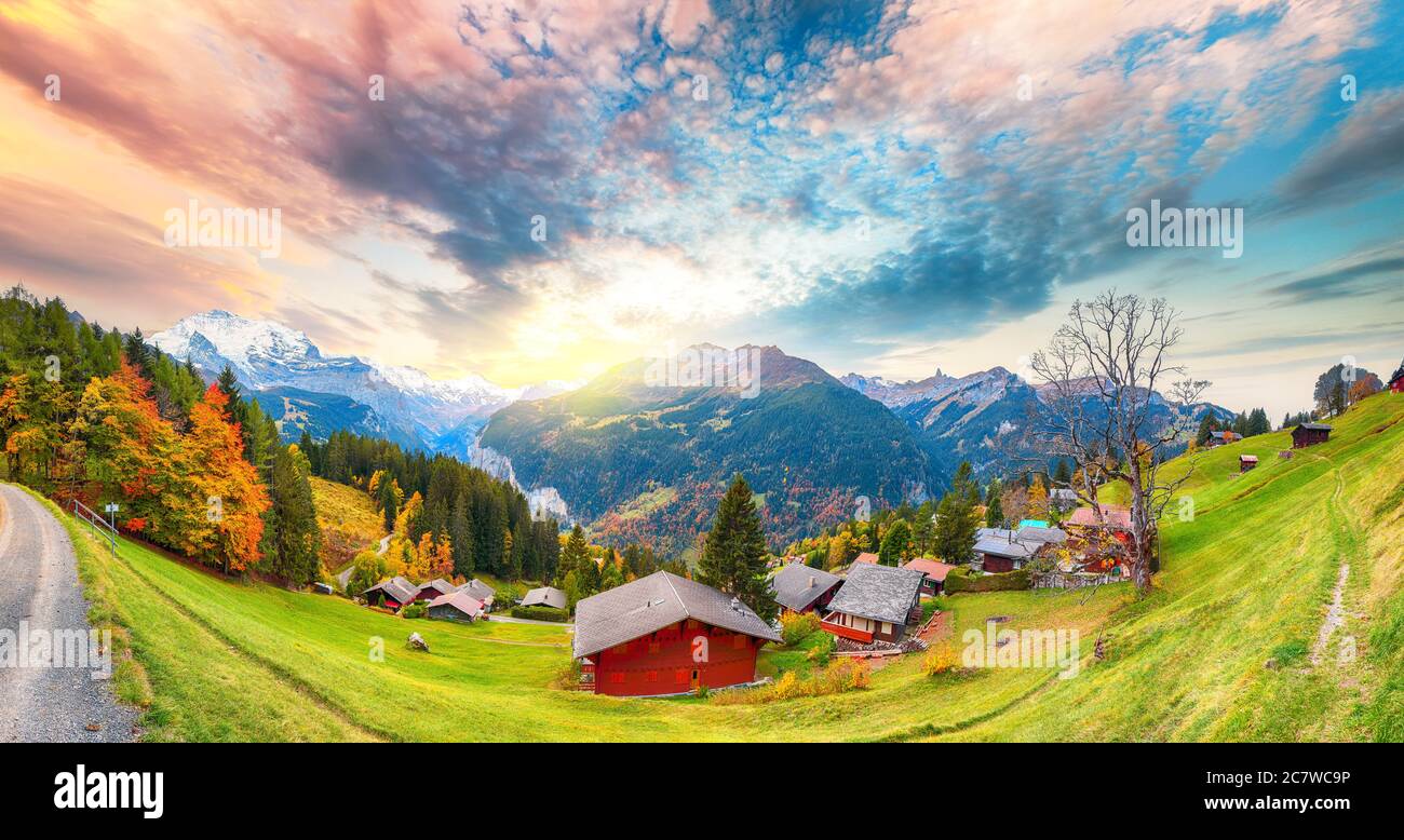 Gorgeous panorama over picturesque alpine village Wengen at autumn. Lauterbrunnen Valley with Jungfrau Mountain on background. Location: Wengen villag Stock Photo