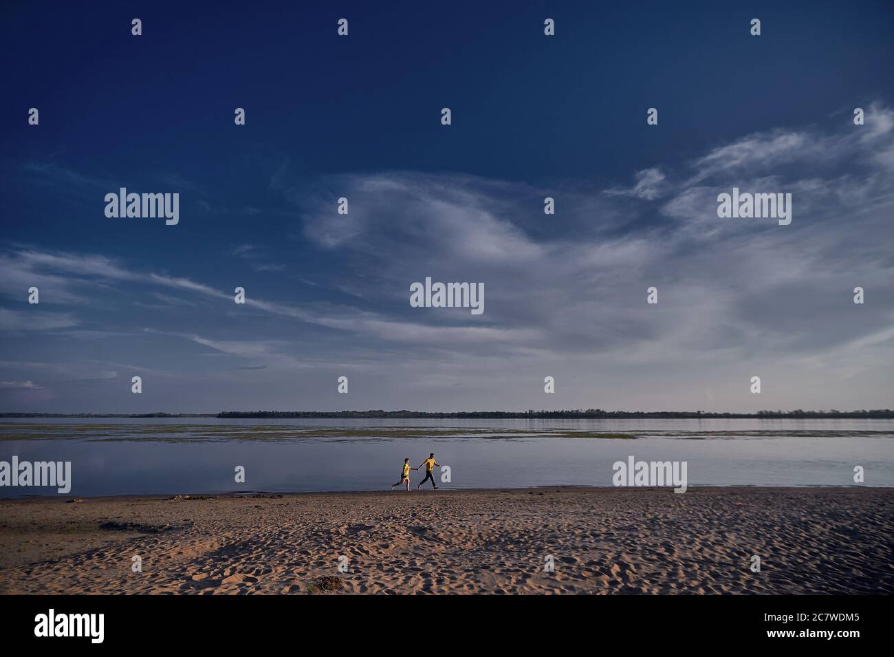 Woman standing along the shore hi-res stock photography and images - Alamy