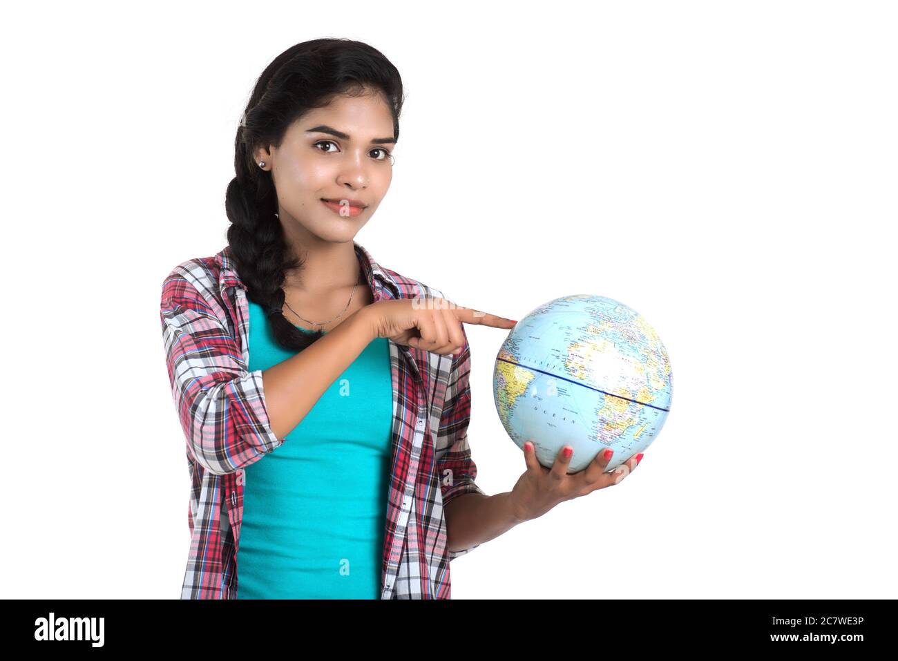 young woman holding the world globe and posing on a white background ...