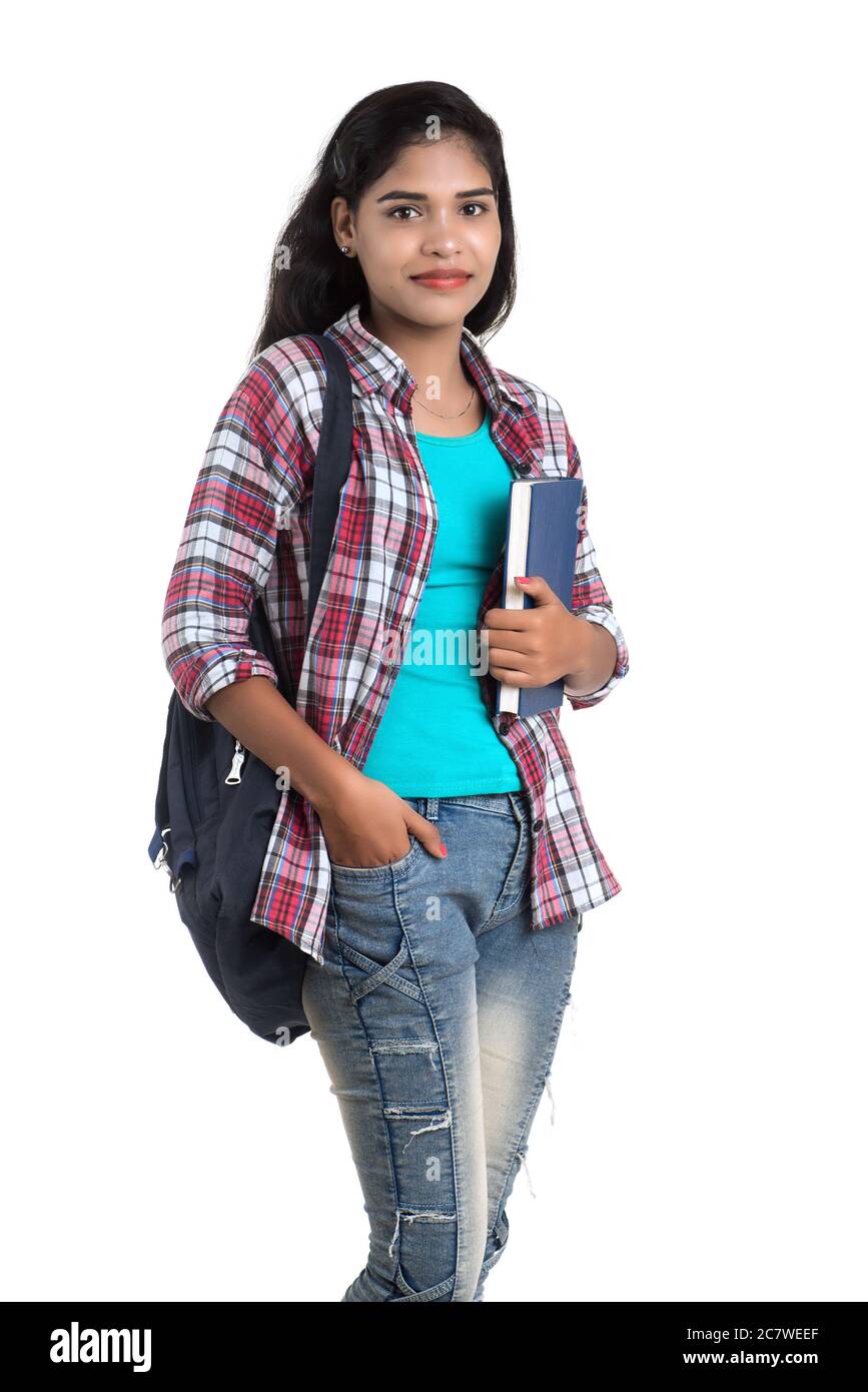 young Indian woman with backpack standing and holding notebooks, posing ...