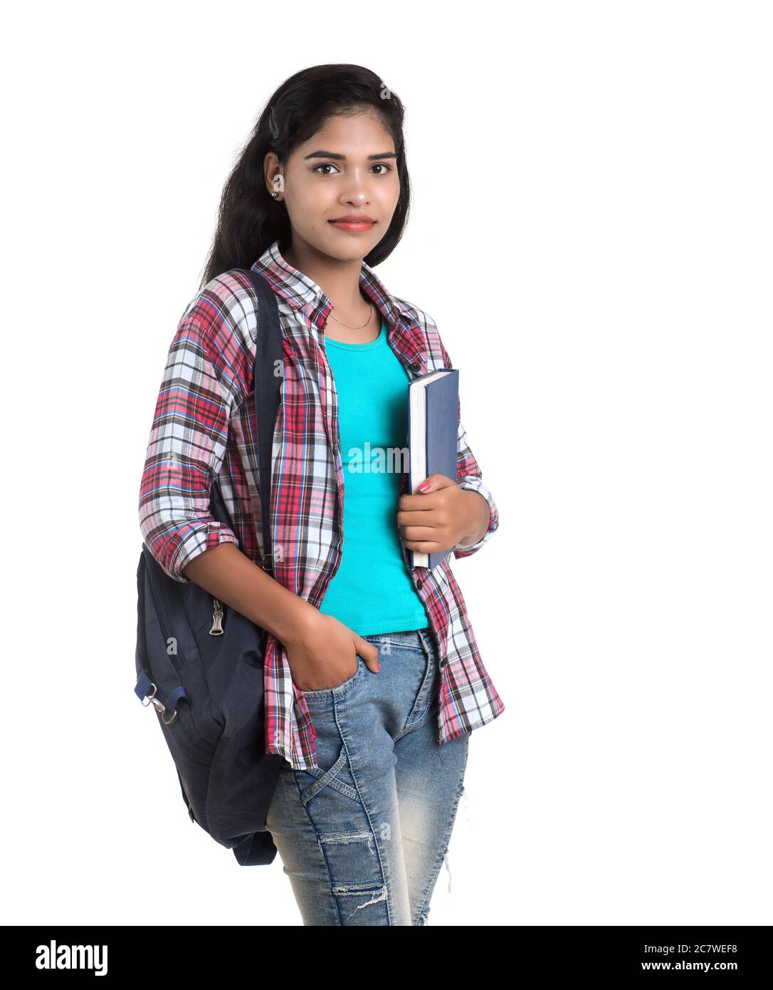 young Indian woman with backpack standing and holding notebooks, posing ...