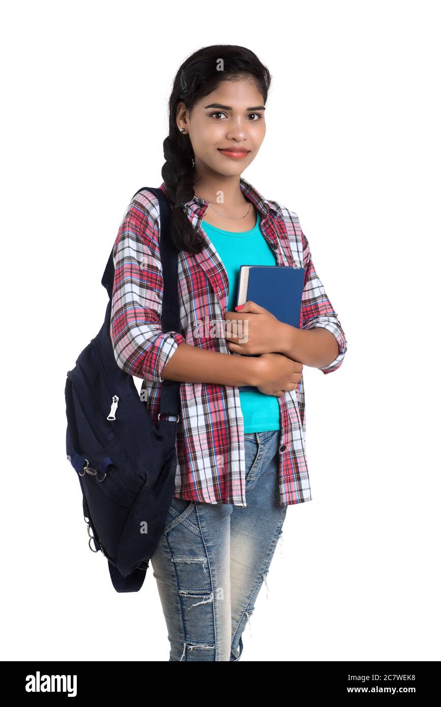 young Indian woman with backpack standing and holding notebooks, posing ...