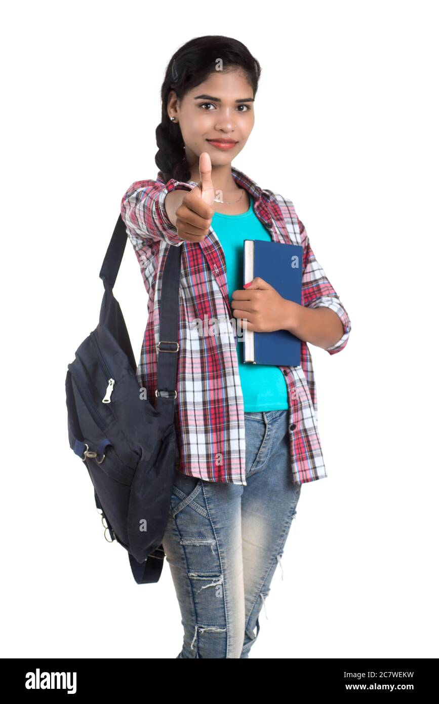 young Indian woman with backpack standing and holding notebooks, posing ...