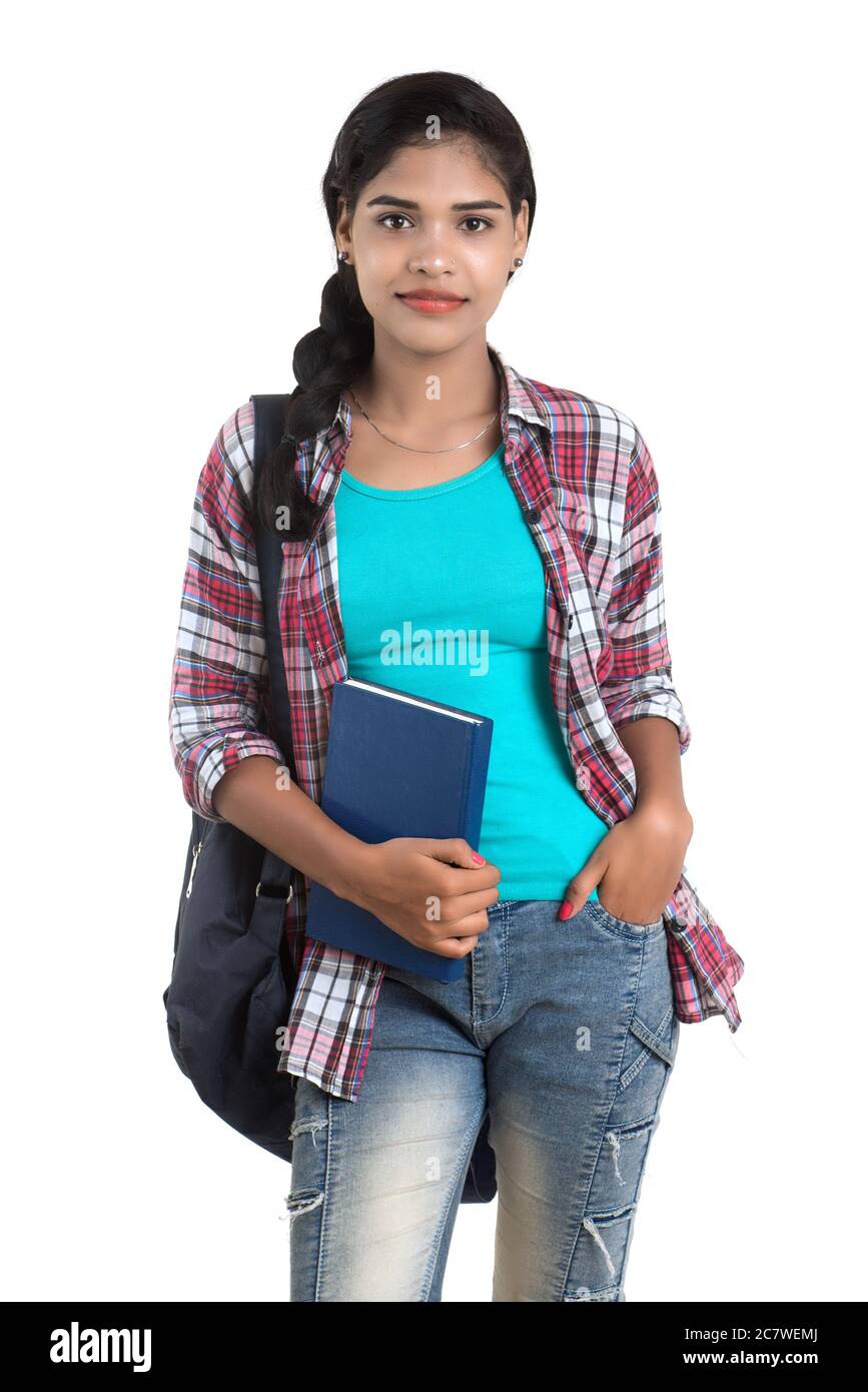 young Indian woman with backpack standing and holding notebooks, posing ...