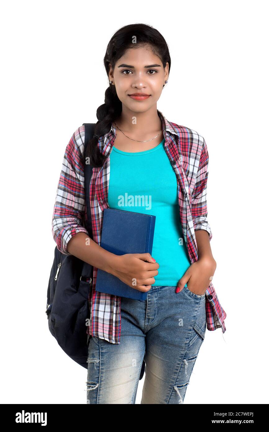 young Indian woman with backpack standing and holding notebooks, posing ...