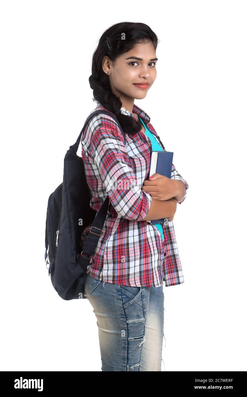 young Indian woman with backpack standing and holding notebooks, posing ...