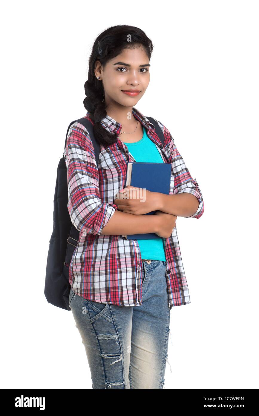 young Indian woman with backpack standing and holding notebooks, posing ...