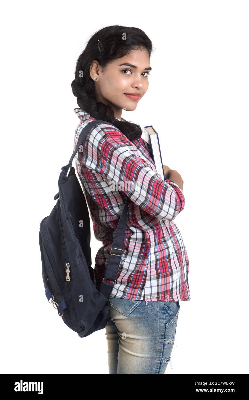young Indian woman with backpack standing and holding notebooks, posing ...