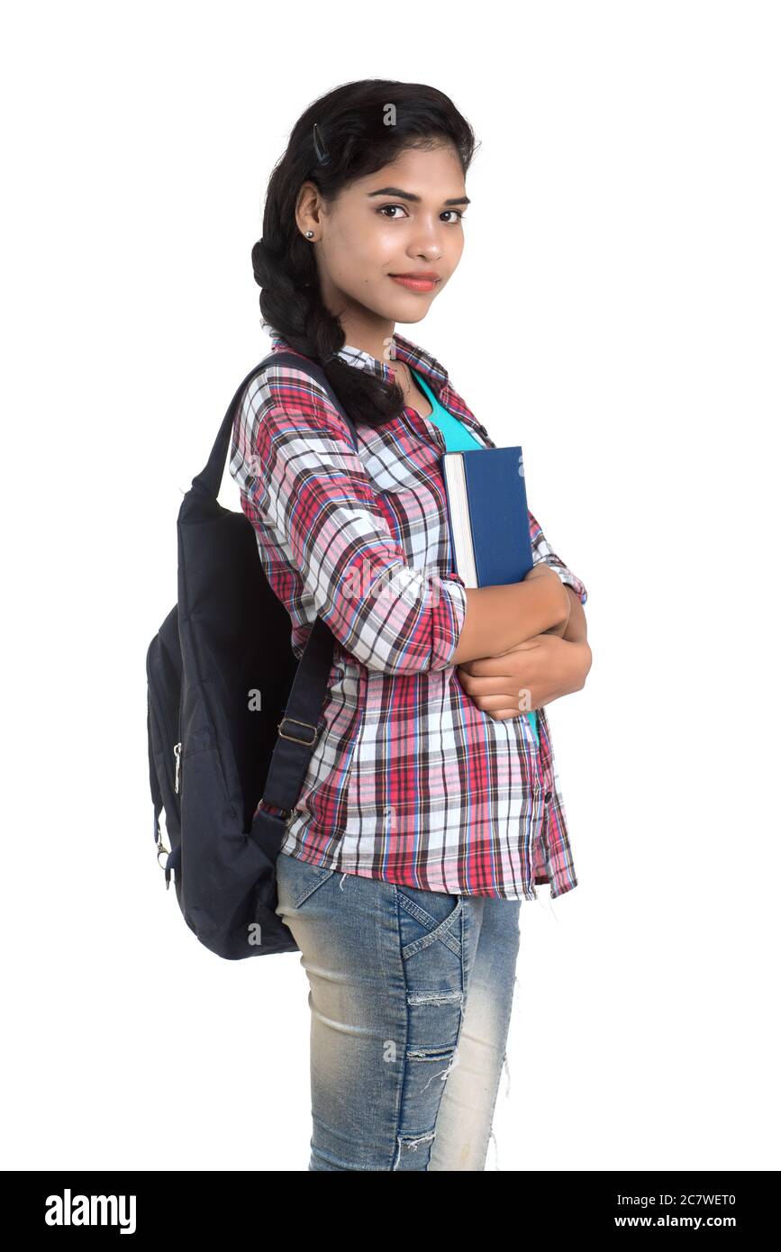 young Indian woman with backpack standing and holding notebooks, posing ...