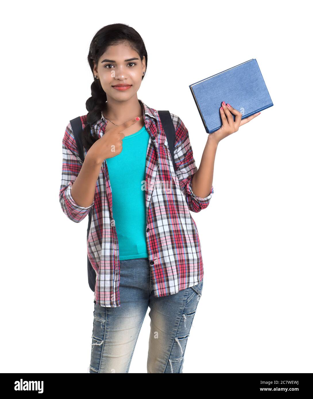 young Indian woman with backpack standing and holding notebooks, posing ...
