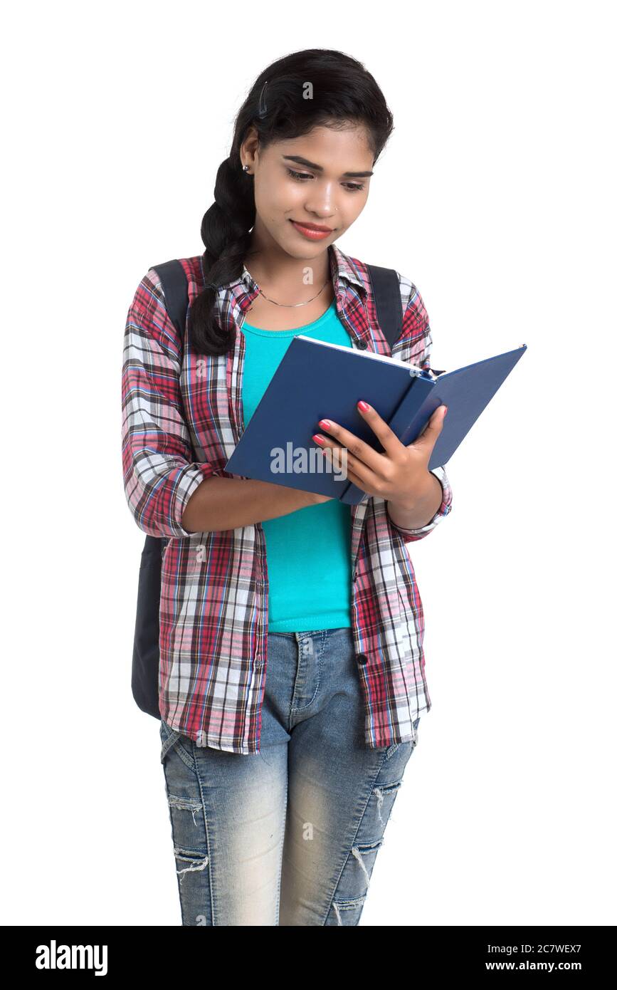 young Indian woman with backpack standing and holding notebooks, posing ...