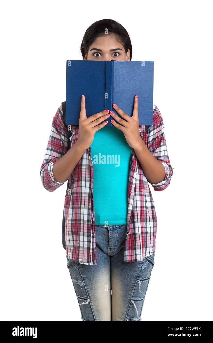 young Indian woman with backpack standing and holding notebooks, posing ...