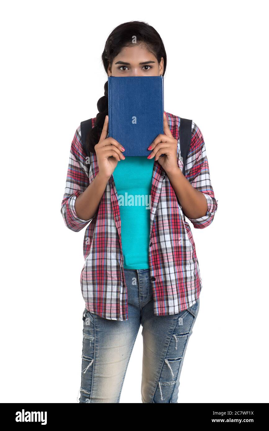 young Indian woman with backpack standing and holding notebooks, posing ...