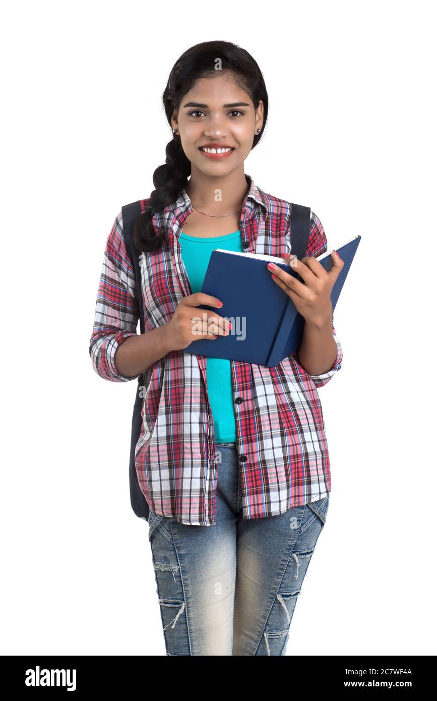 young Indian woman with backpack standing and holding notebooks, posing ...