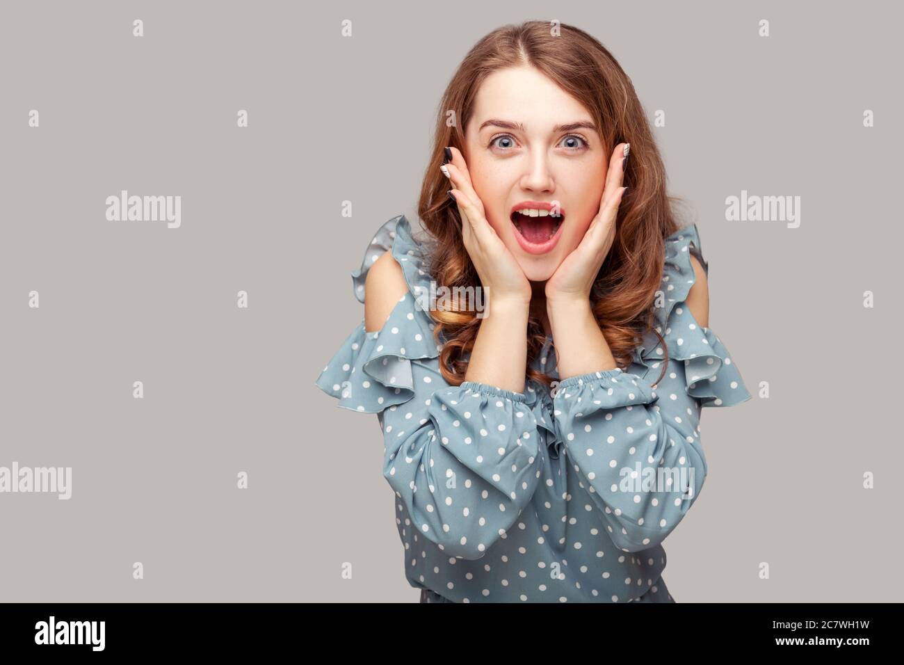 Oh my god, wow! Surprised excited brunette girl ruffle blouse touching face  looking at camera amazed, open mouth in astonishment, shocked by unbelieva  Stock Photo - Alamy