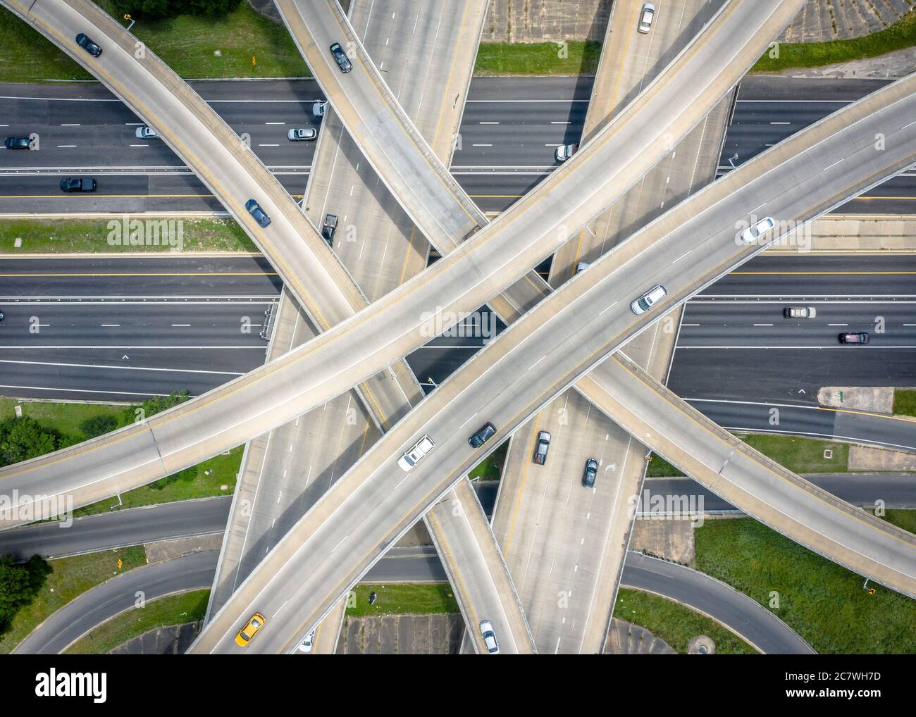 Aerial shot of an overpass with cars on different levels and green ...