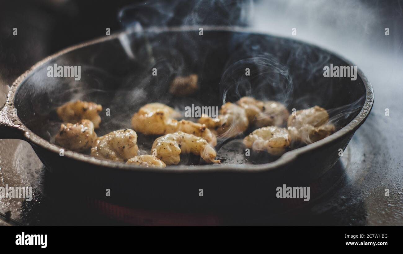 Closeup shot of delicious cooking shrimps in a cast-iron skillet Stock Photo