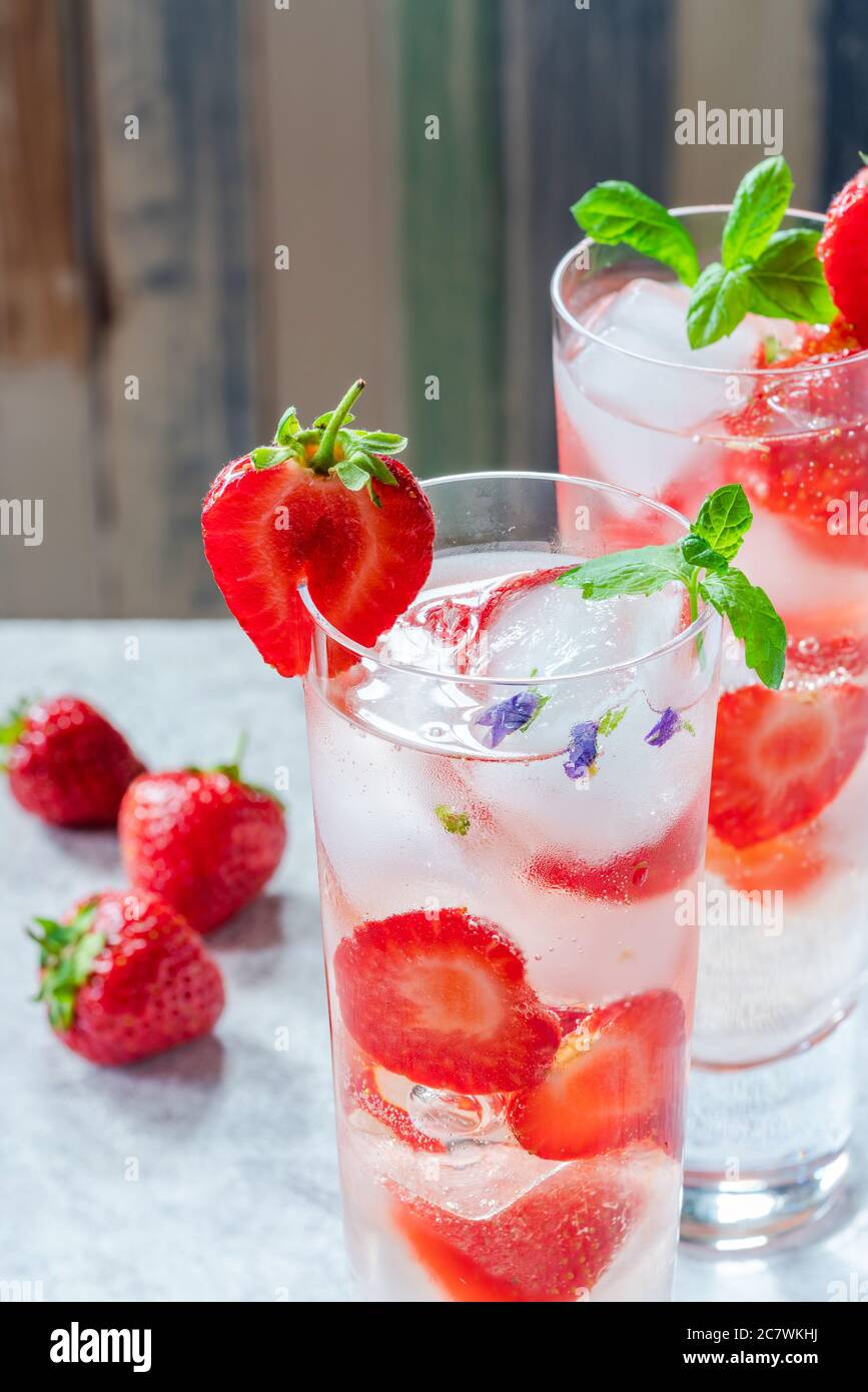 Elderflower and vodka cocktail with strawberries, tonic water and ice