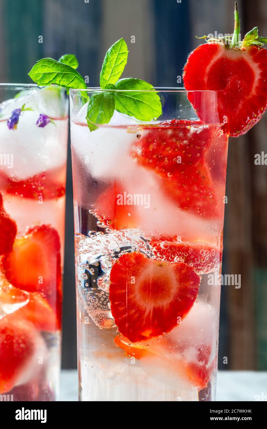 Elderflower and vodka cocktail with strawberries, tonic water and ice