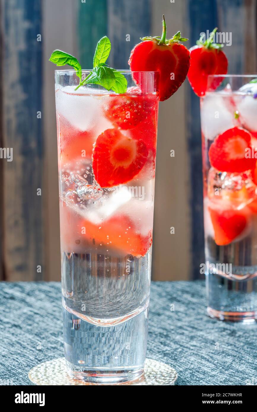 Elderflower and vodka cocktail with strawberries, tonic water and ice
