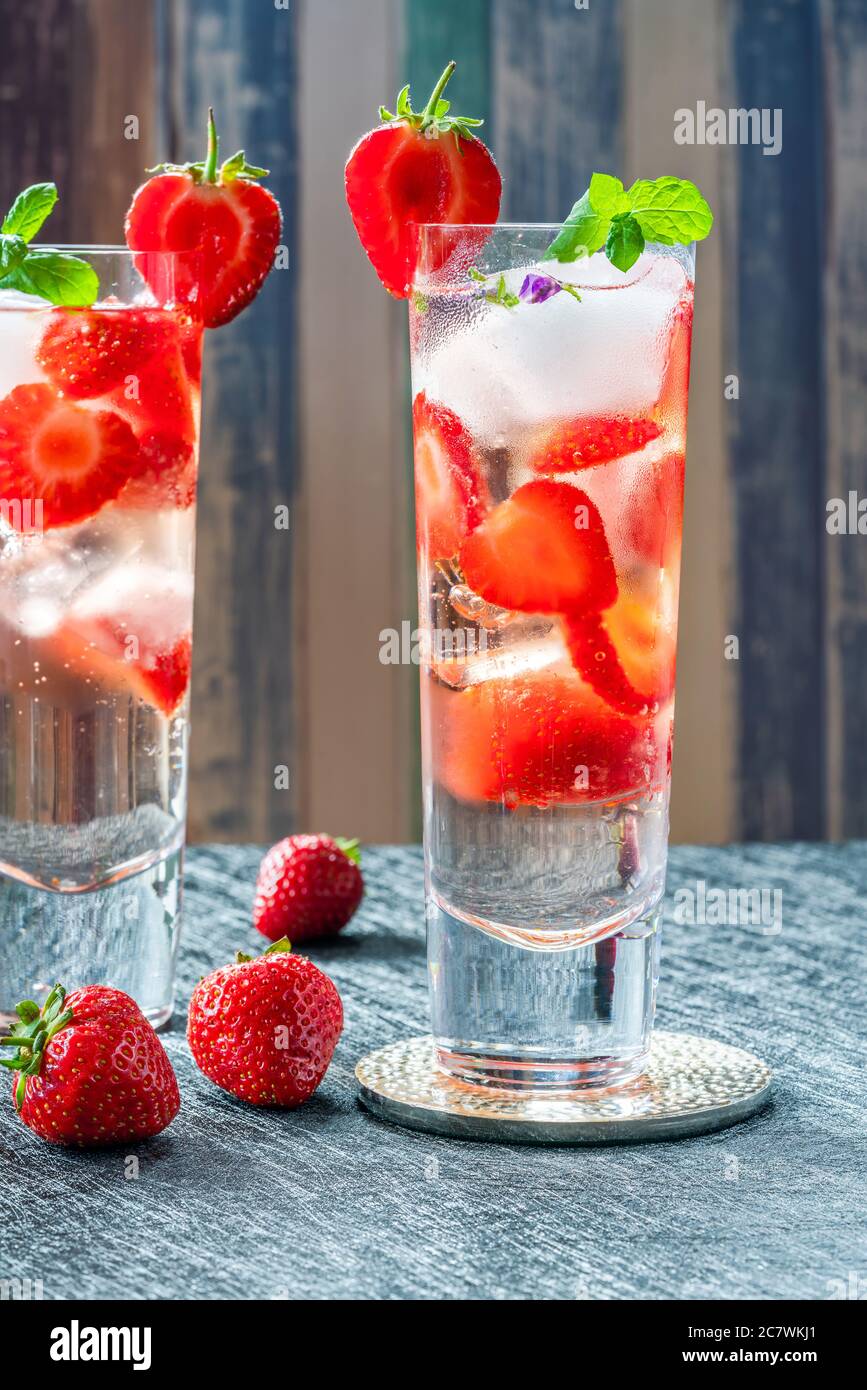 Elderflower and vodka cocktail with strawberries, tonic water and ice