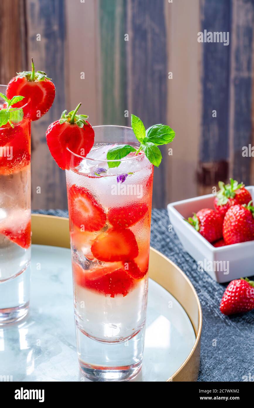 Elderflower and vodka cocktail with strawberries, tonic water and ice