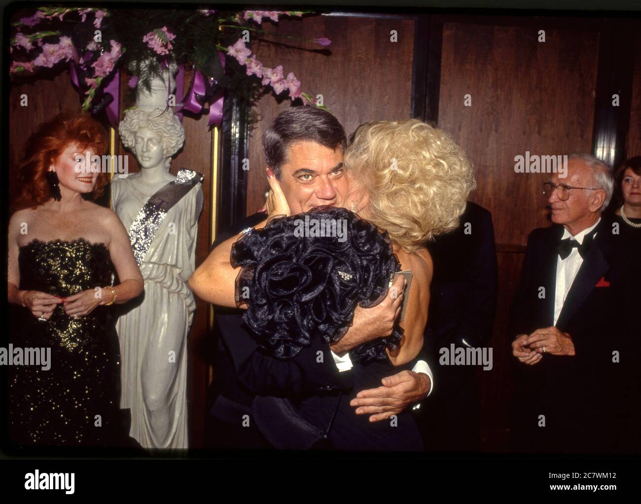 Film critic Rex Reed gets a hug from Ruta Lee at at Gala in Beverly Hills, CA Stock Photo