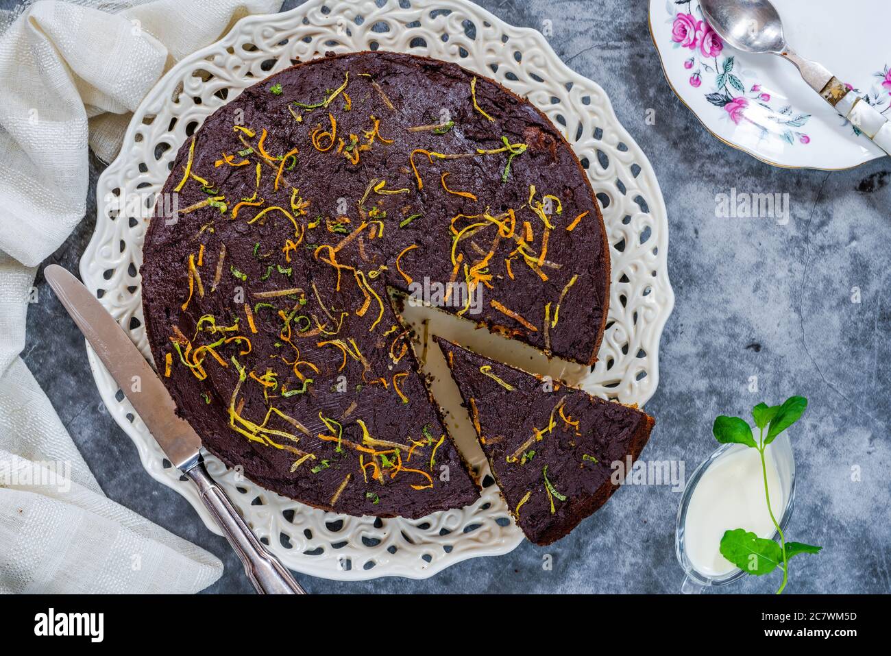 Orange and poppy seed cake with chocolate ganache overhead view Stock