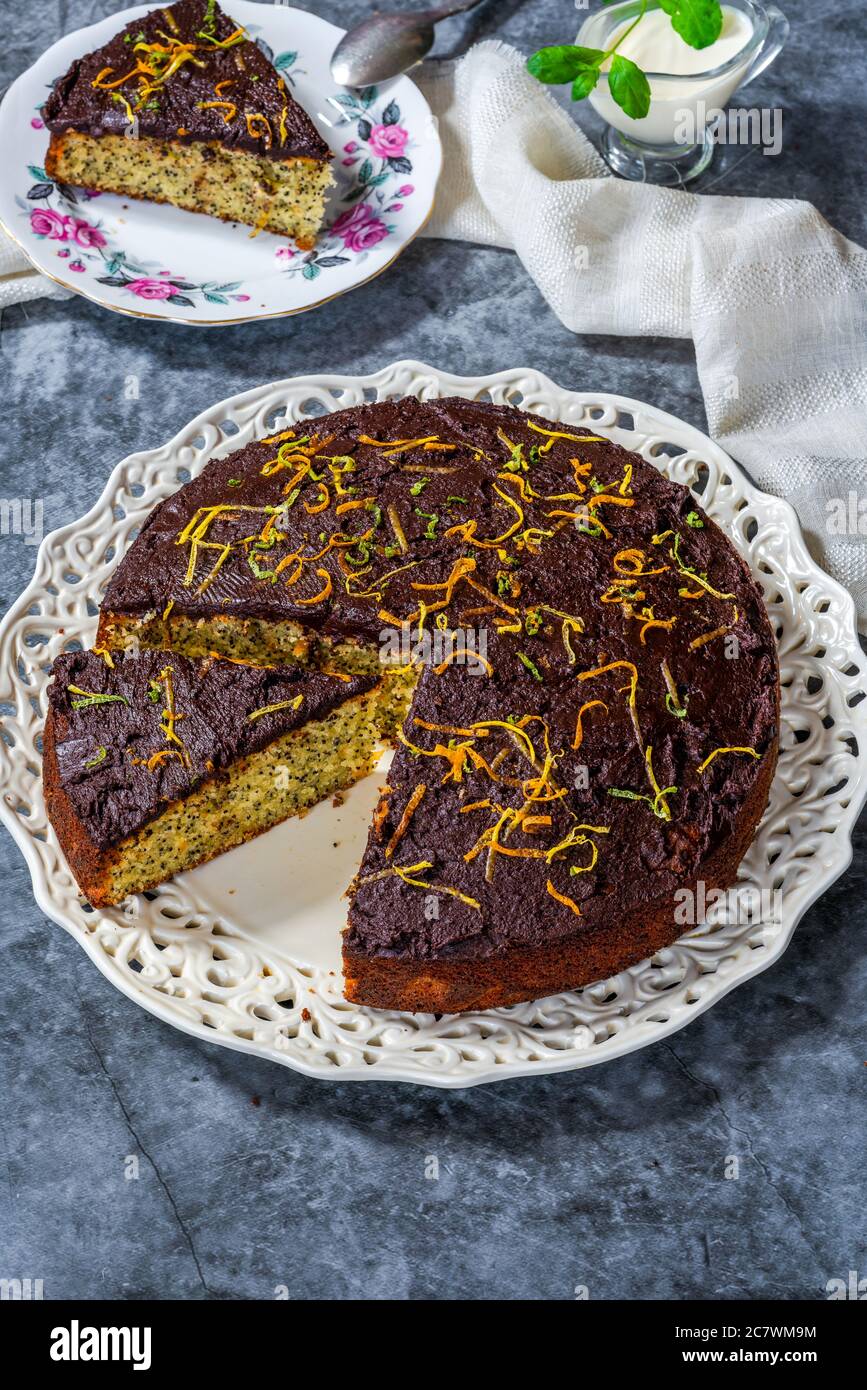 Orange and poppy seed cake with chocolate ganache Stock Photo Alamy