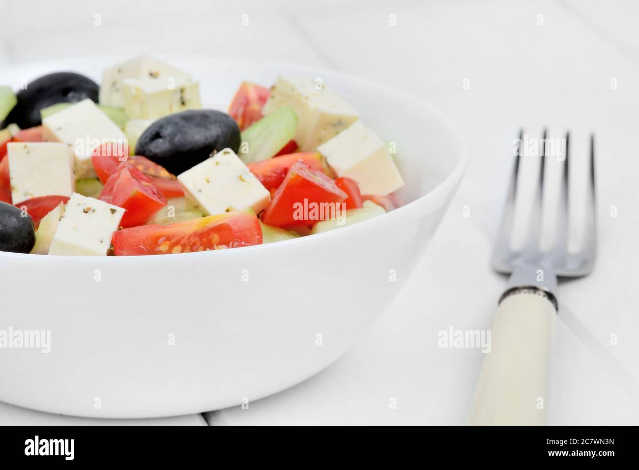 Vegetable salad in a bowl on a white wood table Stock Photo