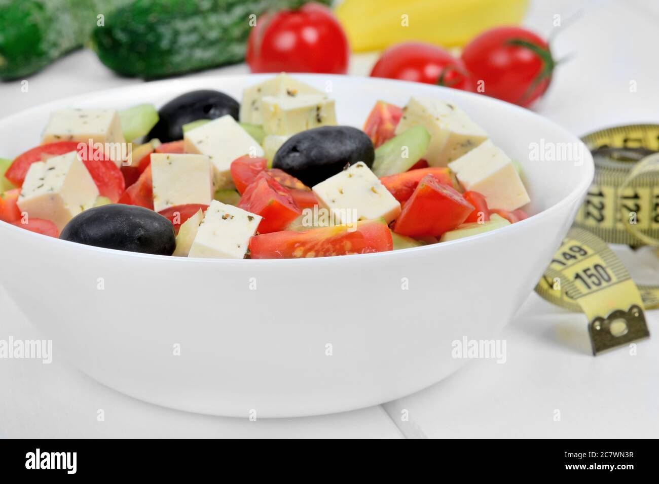 Vegetable salad in a bowl on a wood table with centimeter close-up Stock Photo