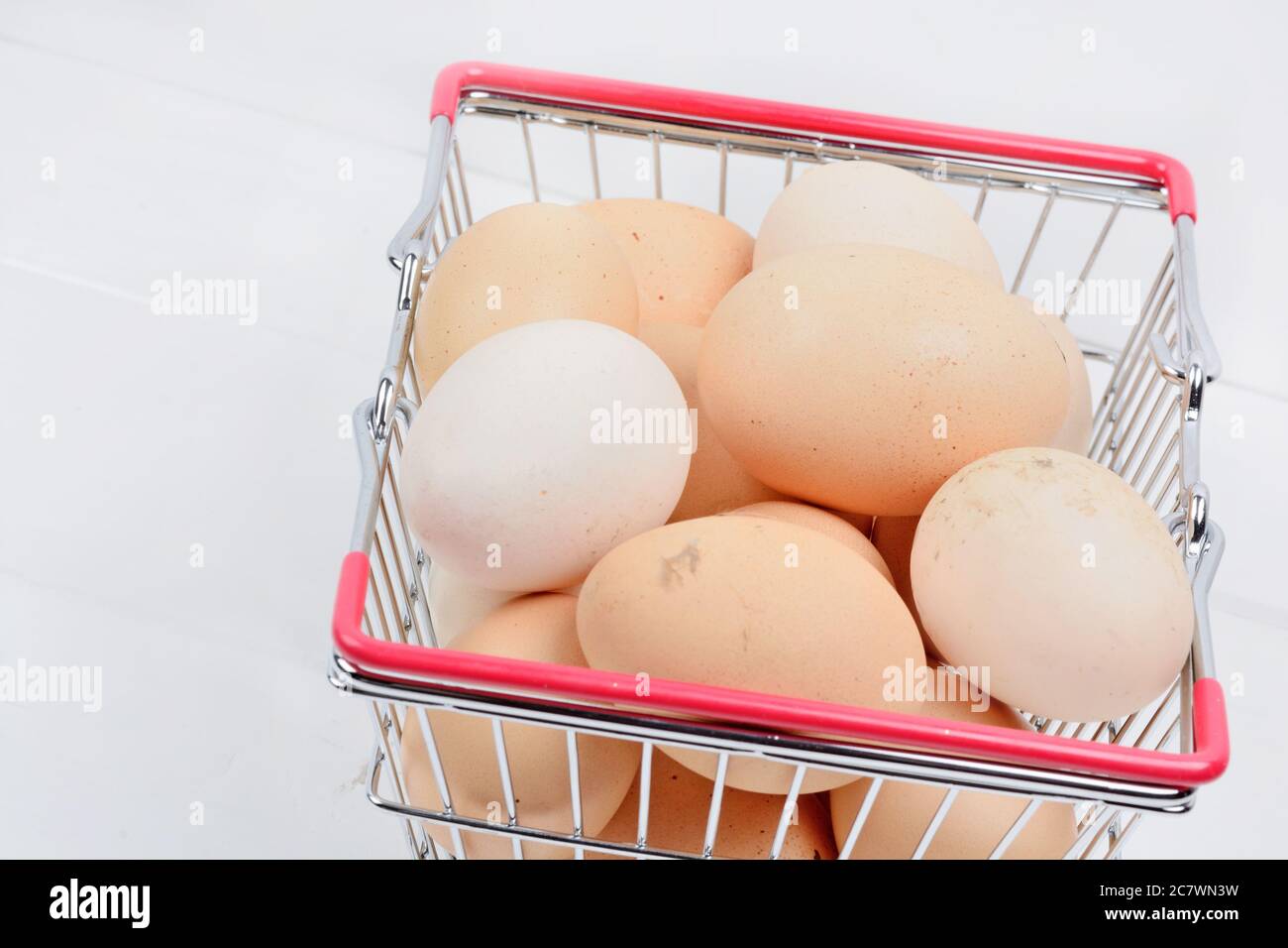 Group of eggs in a shopping cart on a wood table close-up Stock Photo