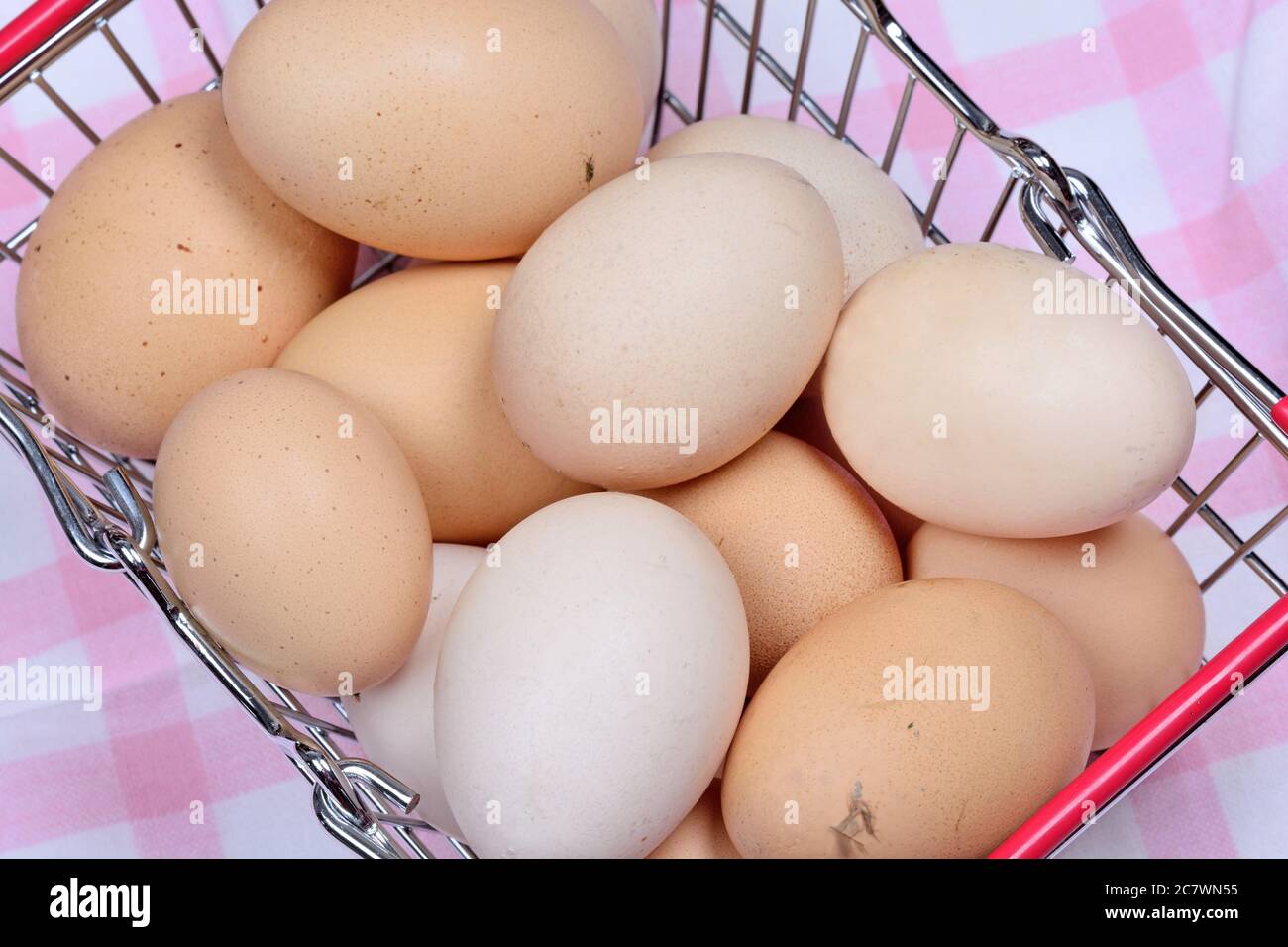 Eggs in a shopping cart on table Stock Photo